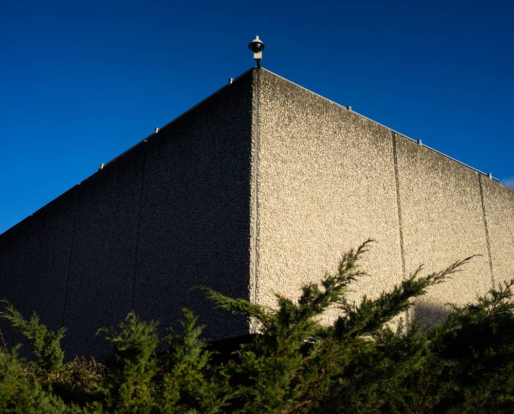 A cctv camera on a brutalist building