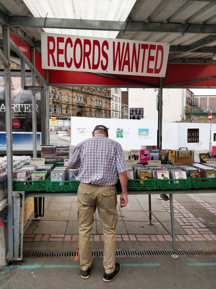 Man browsing records stall at market